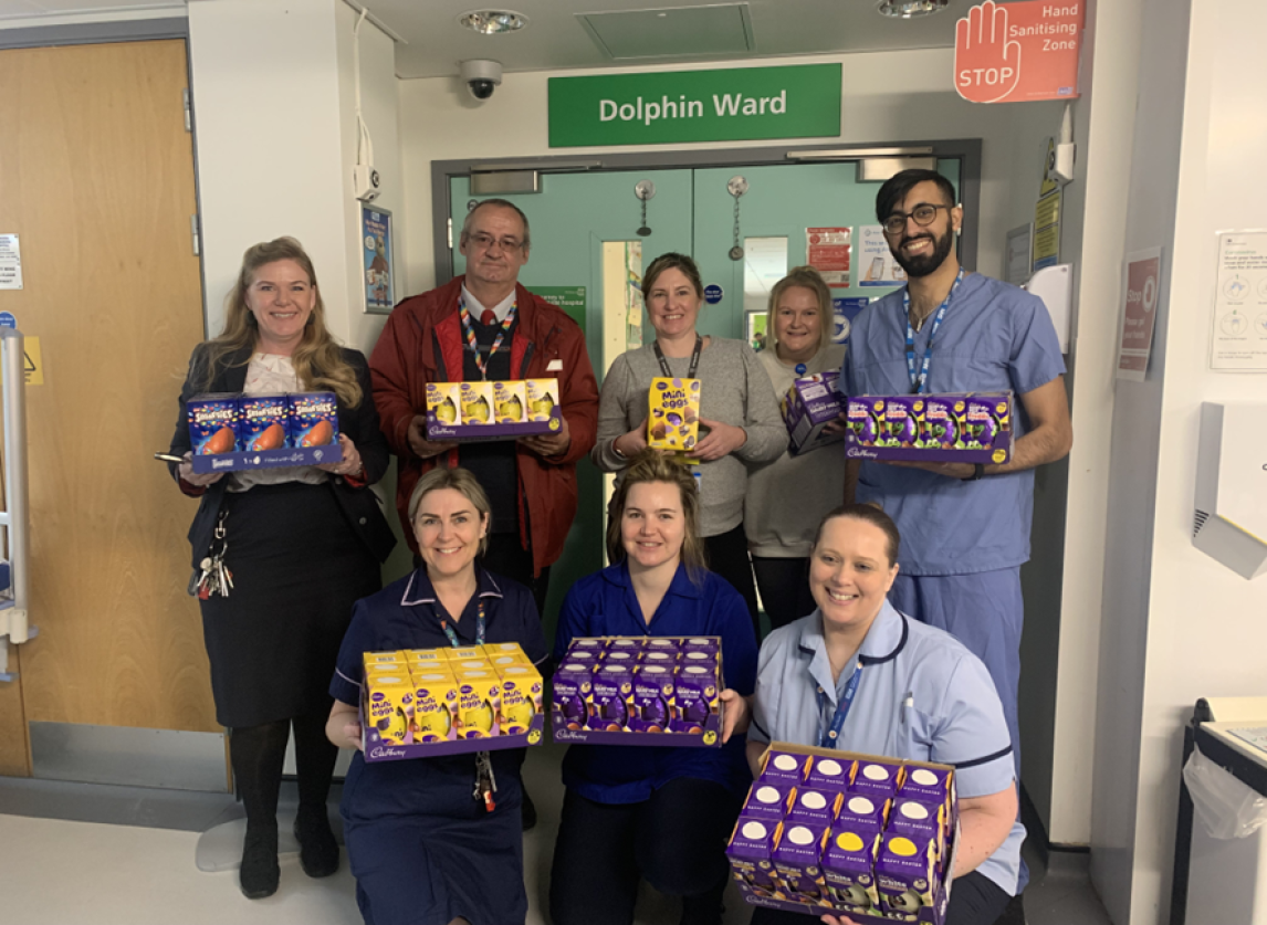 Michael King (red jacket) and hospital staff pose with the donated Easter eggs (supplied by PAHT)